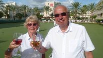 A couple enjoy a glass of wine on a bowls holiday
